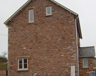 Sandblasting stonework clean during house renovation.