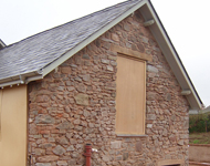Sandblasting stonework clean during house renovation.