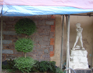 Front of hotel during sandblasting: Stone walls begin to become exposed.