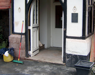 Front of hotel during sandblasting: Stone walls begin to become exposed.