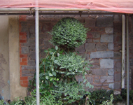 Front of hotel during sandblasting: Stone walls begin to become exposed.