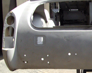 Car body being cleaned by sandblasting.