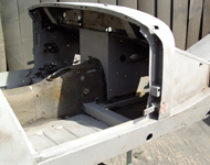 Car body being cleaned by sandblasting.