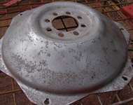 Vintage tractor wheel before sandblasting and refinishing.